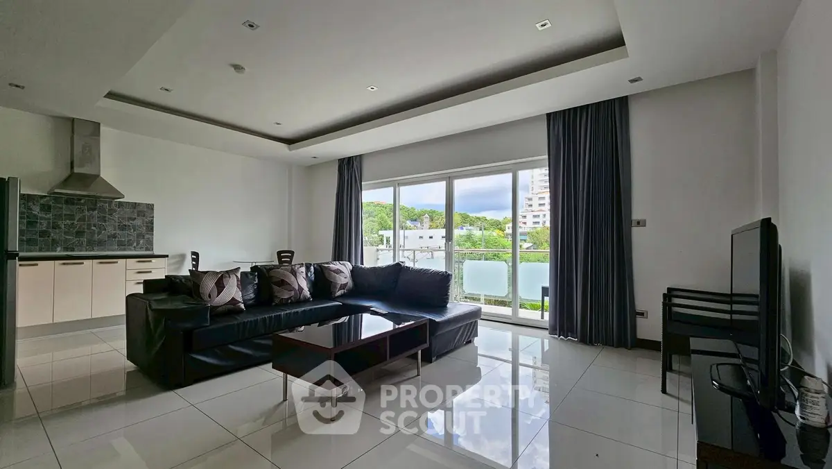 Spacious modern living room with sleek furniture and large windows offering natural light.