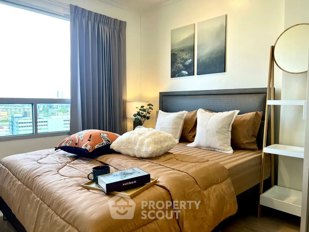 Cozy bedroom with stylish decor and city view, perfect for urban living.
