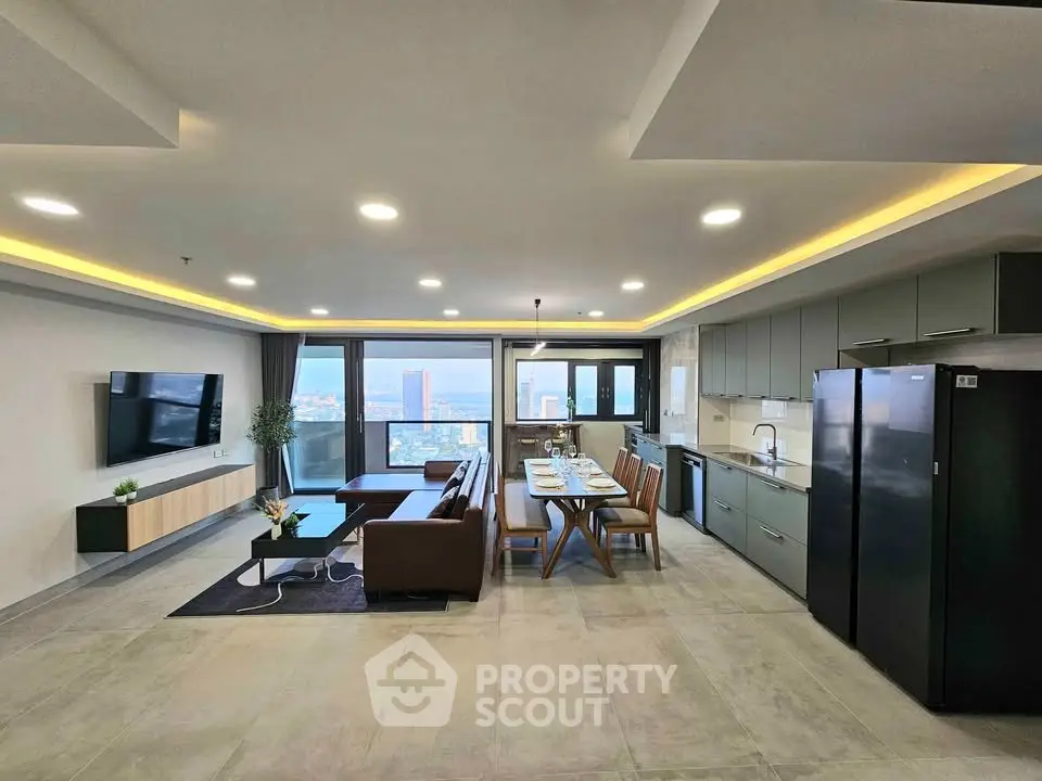 Spacious modern living room with open kitchen and stunning city view, perfect for urban living.