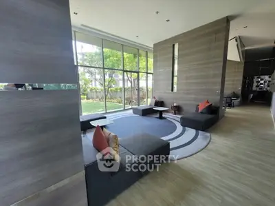 Modern living room with large windows and stylish seating area