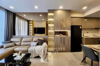 Modern living room with elegant decor and open kitchen layout in a stylish apartment.