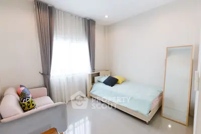 Bright and cozy bedroom with modern decor and natural light.