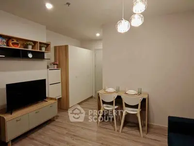 Modern living room with dining area, stylish furniture, and elegant lighting