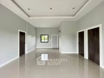 Spacious modern living room with high ceilings and elegant tile flooring