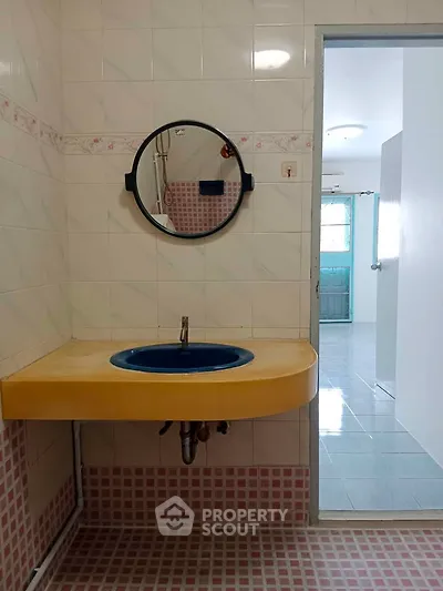 Charming bathroom with unique blue sink and vintage tile design
