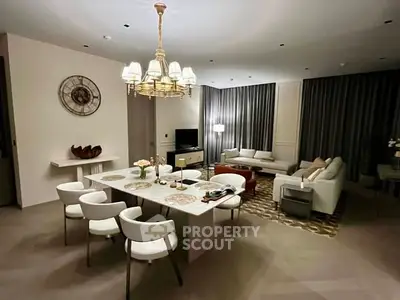 Luxurious open-plan living and dining area with elegant decor and modern lighting.