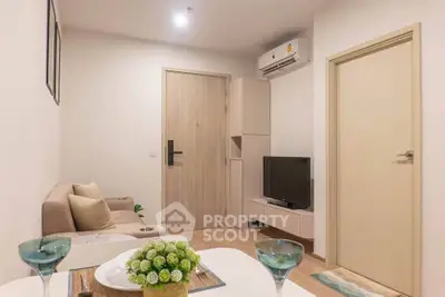 Cozy modern living room with stylish decor and air conditioning, perfect for relaxation.