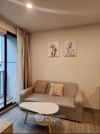 Cozy living room with modern decor and balcony access in a stylish apartment.