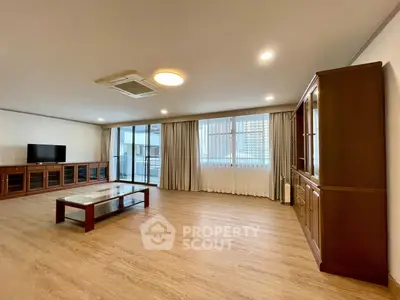 Spacious living room with modern furnishings and large windows for natural light