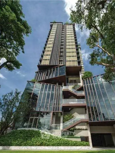 Stunning modern high-rise building with lush greenery and sleek architectural design.