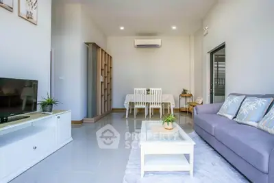 Modern living room with sleek furniture and air conditioning, perfect for relaxation.