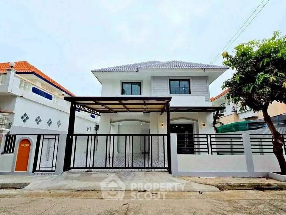 Charming two-story house with modern design and spacious driveway in a serene neighborhood.