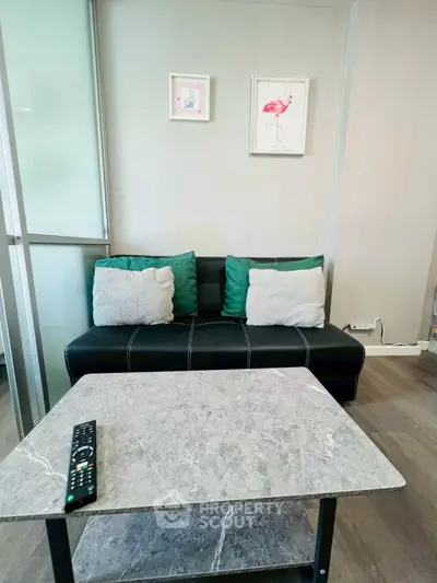 Cozy living room with modern sofa and marble coffee table, perfect for relaxation.