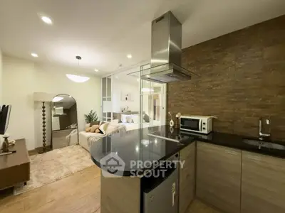 Modern open-plan kitchen and living area with stylish decor and cozy ambiance.