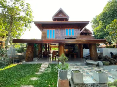 Charming traditional wooden house with lush garden and spacious outdoor area, perfect for serene living.