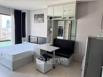 Modern studio apartment with sleek furniture and city view