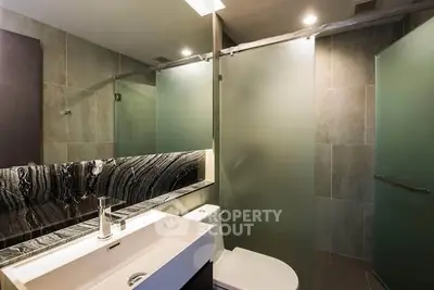 Modern bathroom with sleek design and glass shower enclosure