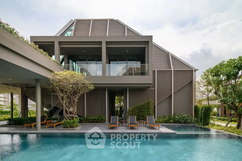 Luxurious modern villa with sleek architecture and private pool, surrounded by lush greenery, offering serene outdoor living.