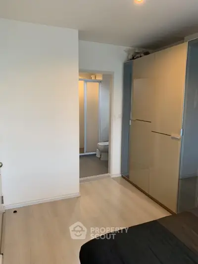 Modern bedroom with sleek wardrobe and en-suite bathroom