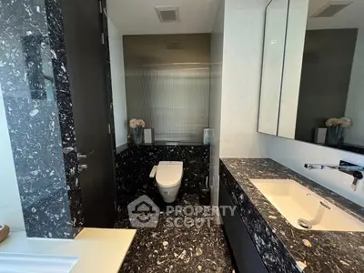 Luxurious modern bathroom with sleek black marble and elegant fixtures