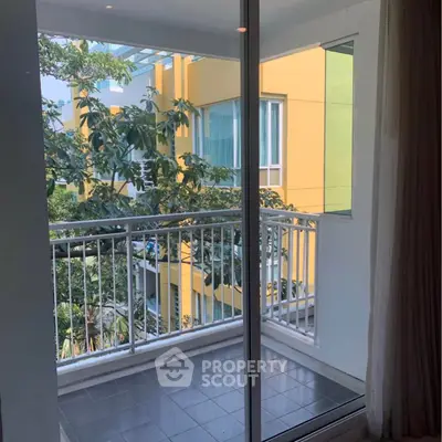 Charming balcony view with lush greenery and modern architecture, perfect for relaxation and enjoying nature.