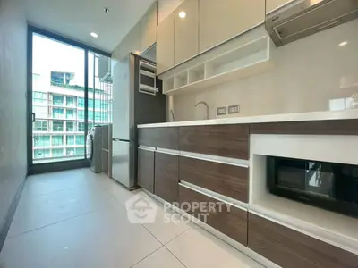 Modern kitchen with sleek cabinetry and appliances in a high-rise apartment