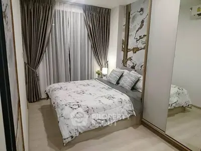 Elegant bedroom with stylish decor and large mirrored wardrobe
