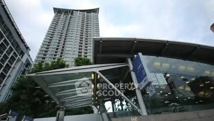Modern high-rise building with glass entrance and urban architecture.