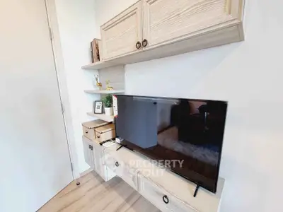 Modern living room with sleek TV setup and stylish wooden shelves
