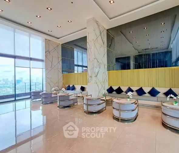 Luxurious high-rise building lobby with elegant seating and panoramic city views.