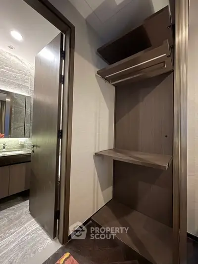 Modern bathroom with open wooden storage shelves and sleek design