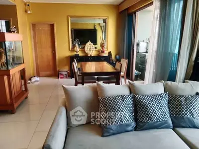 Spacious living room with elegant decor and large windows offering natural light.