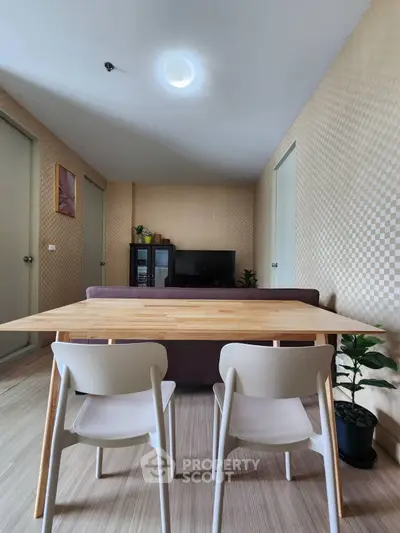 Modern living room with stylish furniture and wooden dining table in a cozy apartment.