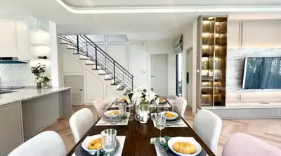 Luxurious open-plan living and dining area with modern kitchen and elegant decor.