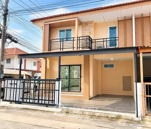Charming two-story house with modern balcony and spacious driveway in a serene neighborhood.