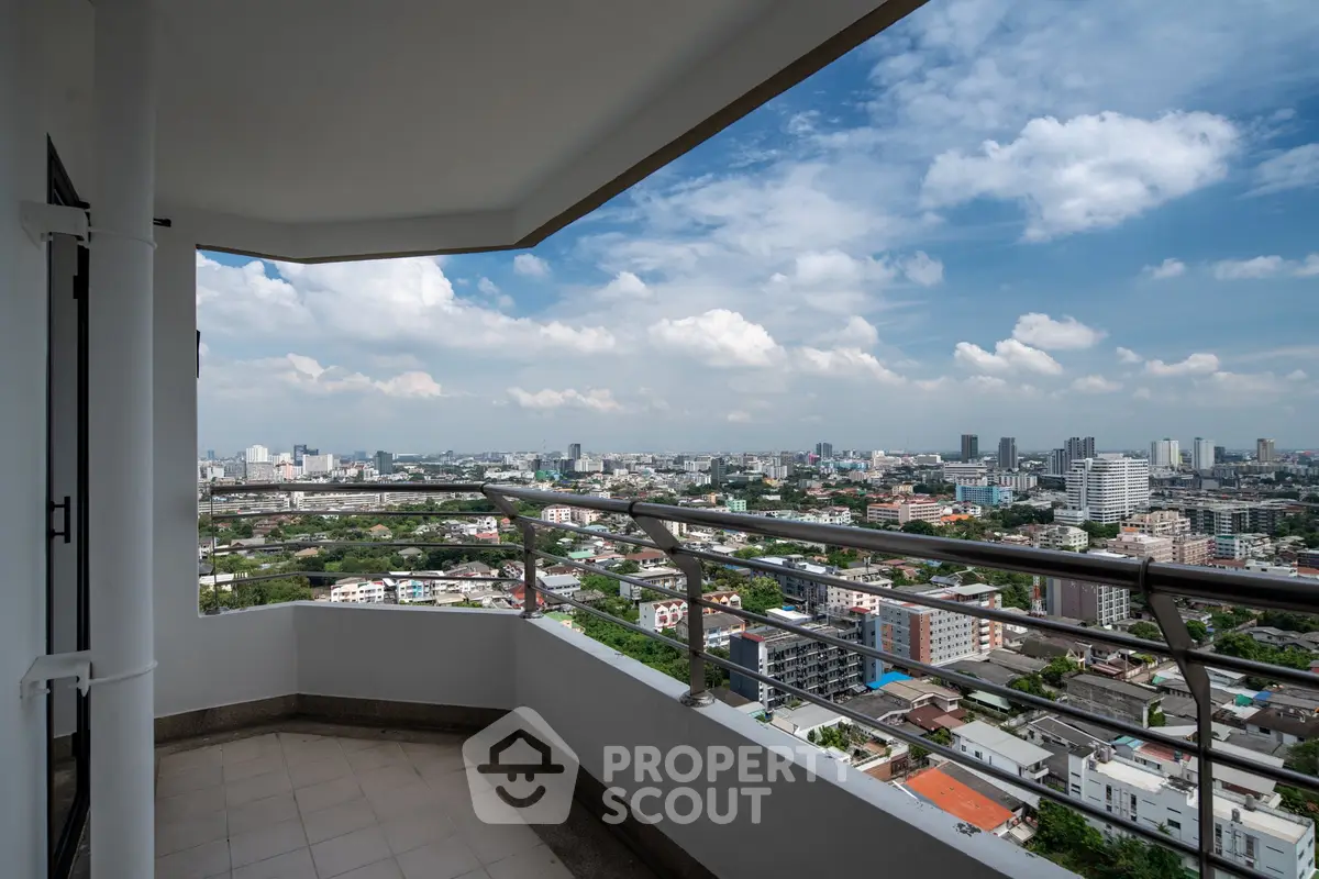 Stunning cityscape view from a spacious balcony in a high-rise apartment.