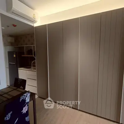 Modern kitchen with sleek cabinetry and integrated appliances in a stylish apartment.