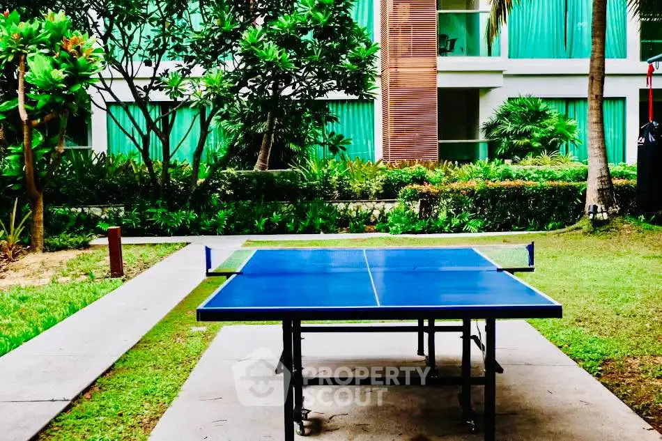 Lush garden with outdoor table tennis in modern residential complex