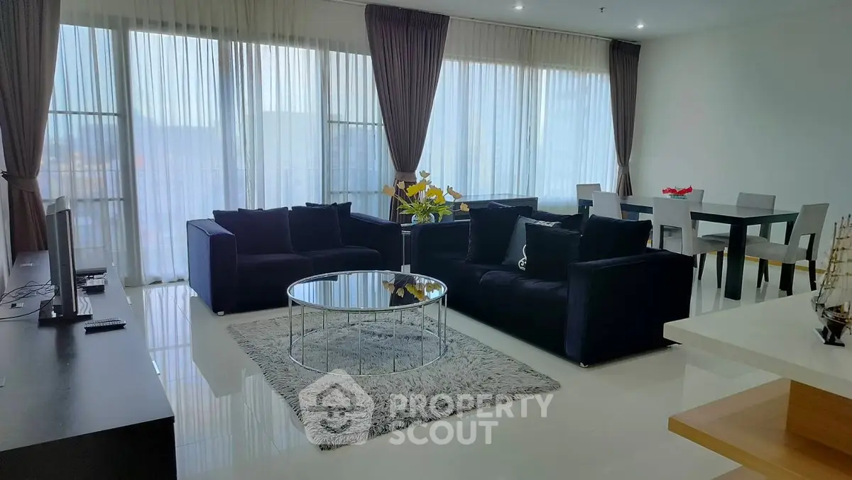 Spacious modern living room with elegant decor and large windows