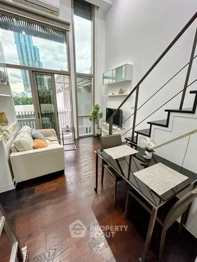 Modern duplex living room with high ceilings and city view