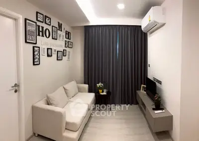 Modern living room with cozy sofa, wall art, and air conditioning in a stylish apartment.