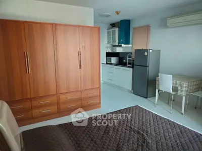 Cozy studio apartment with modern kitchen and ample storage space