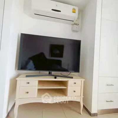 Modern living room with air conditioner and flat-screen TV on elegant wooden stand.