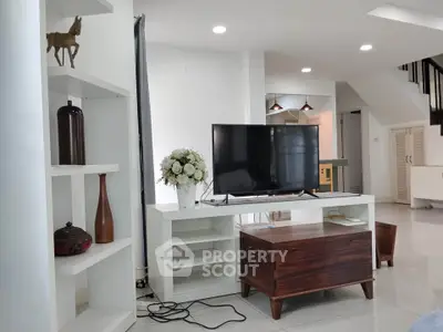 Modern living room with sleek TV stand, elegant decor, and stylish wooden furniture.