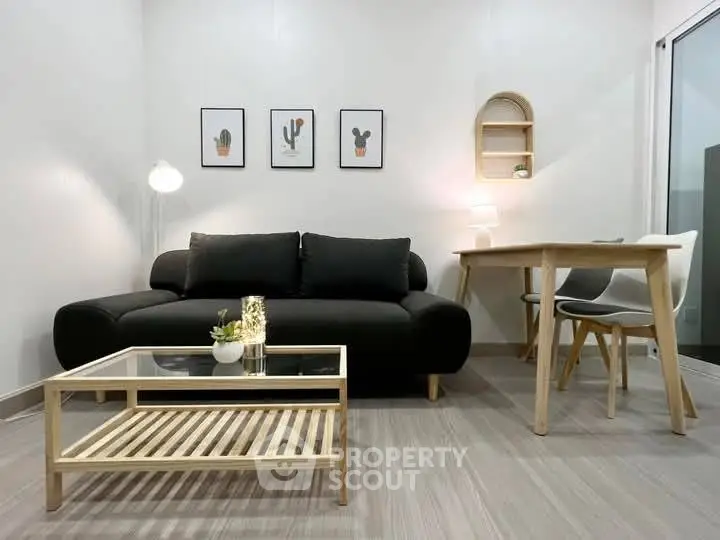 Modern living room with sleek black sofa and minimalist decor