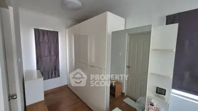 Spacious bedroom with modern wardrobe and wooden flooring