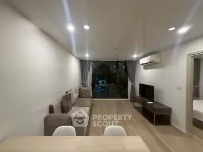 Spacious modern living room with sleek design and large window view