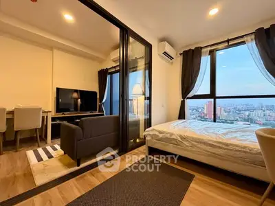 Modern studio apartment with city view, featuring a cozy living area and stylish bedroom.