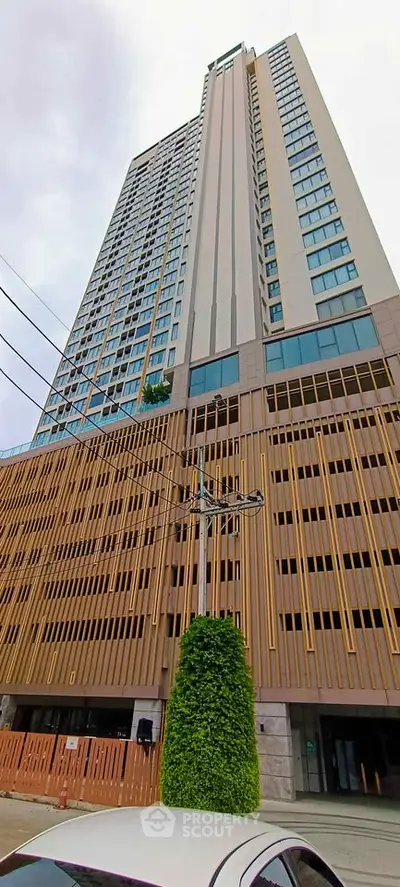 Stunning high-rise building with modern architectural design and expansive windows, perfect for urban living.
