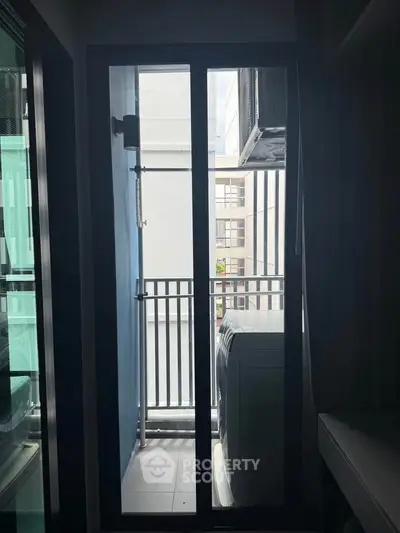 Compact balcony with washing machine and air conditioning unit in modern apartment.